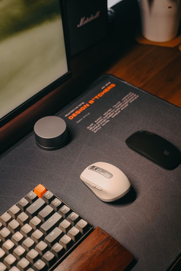 Services A stylish and organized workspace featuring a modern keyboard and mouse on a wooden desk.
