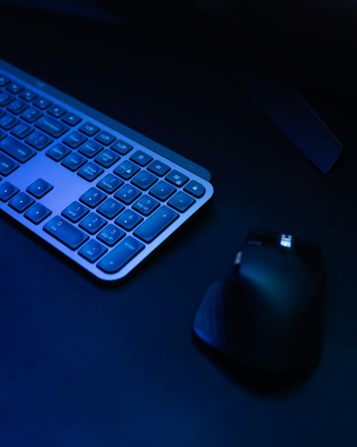 Tigflow | Computer Peripherals Supplier A sleek wireless keyboard and mouse setup under ambient lighting, perfect for tech enthusiasts.